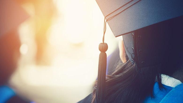 Close up image of female graduate in cap from behind